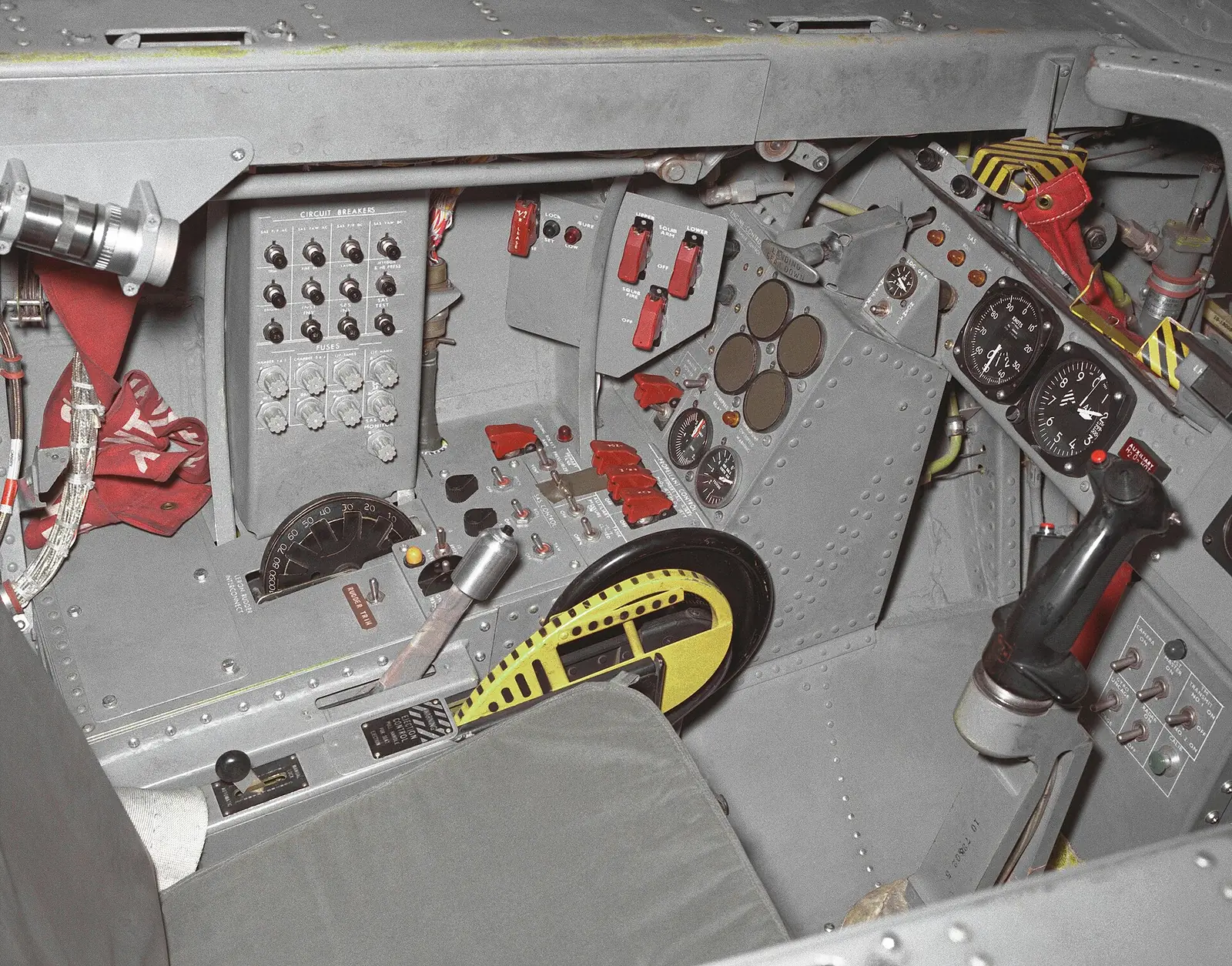 The left side of the M2-F2 lifting body's cockpit, 1966: switches, dials and a grey control stick