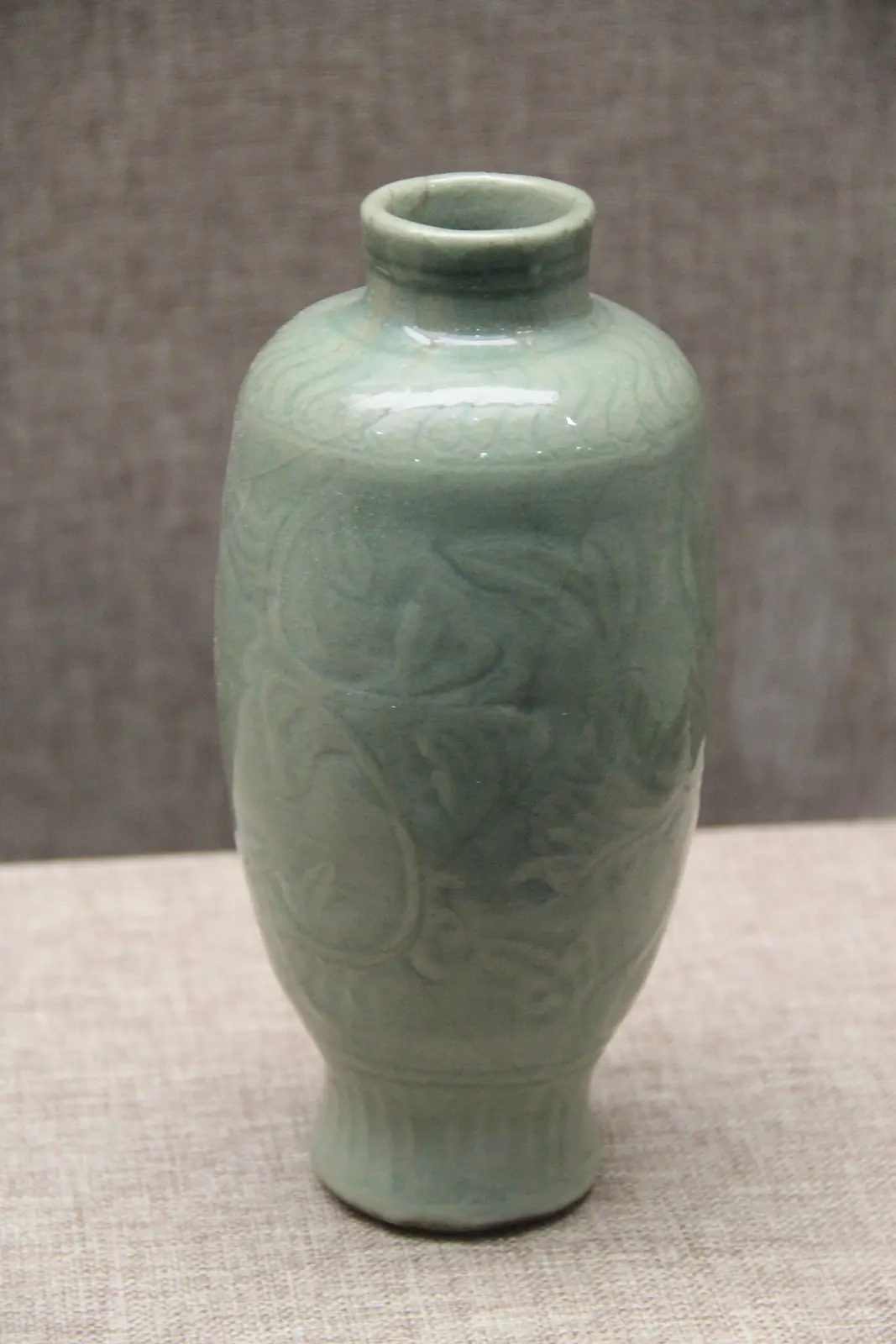 A Ming dynasty porcelain vase in a pale green celadon glaze